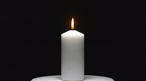 clip-3435285627-serene-candle-flame-against-black-backdrop-perfect