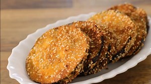 Delicious crispy fried eggplant Ingredients: 1 large eggplant 1 cup (100g) breadcrumbs 1/3 (50g) sesame seeds 2 eggs Salt Pepper Vegetable oil for frying Directions: 1. Slice eggplant into 1 cm (0.4-inch) slices. Place them in a bowl and sprinkle them with salt. allow them to sit for 30 minutes to render some of their liquid and bitterness. 2. After 30 minutes wash eggplant slices from salt and pat dry with a kitchen towel. 3. In a large bowl/plate place breadcrumbs and sesame seeds. In another 