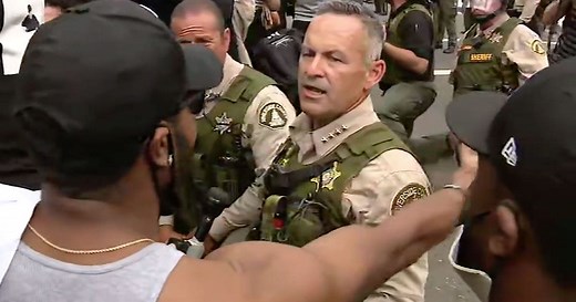 Riverside County Sheriff Chad Bianco and his deputies take a knee in support of protesters
