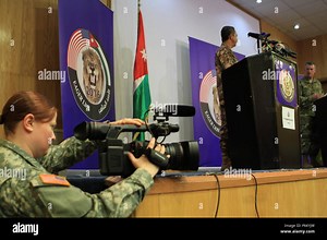 U.S. Army Sgt. Jennifer McAleavey, a broadcast journalist with 368th Public Affairs Det. captures video while Jordanian Brig. Gen. Fahd AL-Damen, the Director of Joint Training Jordanian Armed Forces and  his counterpart, U.S. Army Maj. Gen. Ralph H. Groover III, Director, Exercise and Joint Training Directorate U.S. Central Command, field questions from various media outlets, during a press conference announcing the kick-off of Eager Lion 2016 in Amman, Jordan, May 15, 2016. Eager Lion 2016 is 
