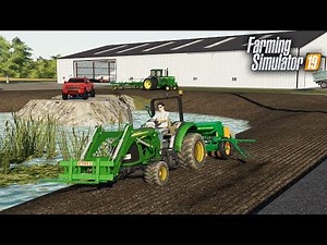 FS19- FIRST LANDSCAPING PROJECT! PLANTING GRASS AROUND THE POND AT THE TRUCK DEALERSHIP