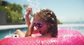 Children, donut and kid jumping in pool, summer party and playing in...