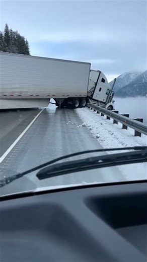 Semi Truck Hanging Over Cliff on Snowy Mountain Highway