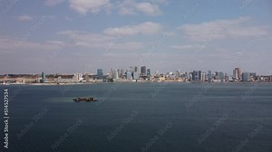 Aerial footage with Luanda Bay and Luanda city downtown, Modern skyscrapers buildings, boats and ships, Port, marina, marginal and central buildings, bay water, Angola