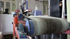 Production of bitumen roll. Rolling conveyors in a factory.