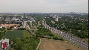 Aerial time lapse of busy traffic on the german autobahn a66 with the cityscape of Frankfurt am Main in the background. Static wide angle shot