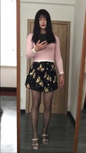 Crossdressing, pink sweater with fishnet stockings.