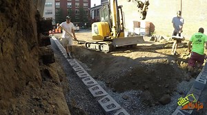 On this 800Sq/Ft engineered retaining wall project in Haverhill Massachusetts, Anchor Wall Systems, Inc. Diamond Pro wall block, purchased from Genest Concrete was selected. A no fines concrete mix of 7:1, 3/4" stone to cement, was installed as the infill material to allow for wall stabilization and 100% drainage permeability. The mix was supplied by Torromeo Industries, Inc. & Divisions. Kingston Red T Mix Concrete of Methuen Massachusetts. After installing the Torpedo block base row, and 1 row
