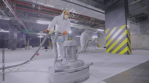 Grinding a concrete floor with a grinder. Builder works concrete floor with special equipment. Concrete floor processing during construction.