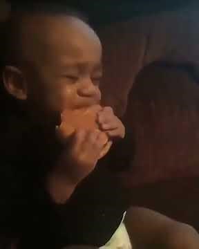 Little boy eating burger crying