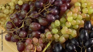 Fresh grapes of different sort rotate as a background. Grape close up, concept winemaking, wine production, vine variety