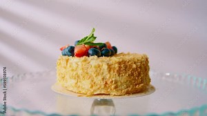 Freshly made delicious Napoleon cake on a light background Puff pastry cake Cake with fresh strawberries and berries