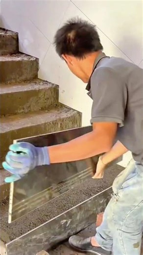 Skilled tile setter installing steps with laser alignment precision