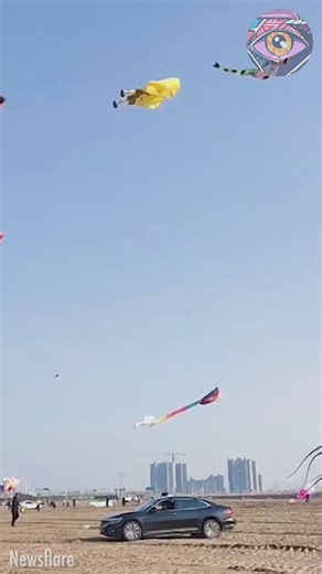 A man soars high in the sky while flying a giant kite | Now I've Seen Everything