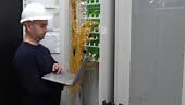 An optical engineer conducts a detailed inspection of optical panels...
