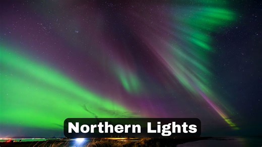 Aurora bands ripple above the ocean shore in Iceland