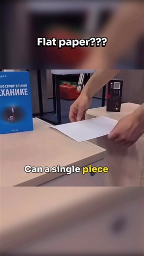 Shape changes everything! 🤯📐 Watch how changing the shape of a standard piece of paper completely transforms its structural integrity. If you lay it flat, it instantly buckles under the weight. But by folding it into a corrugated accordion pattern, the paper is able to distribute the weight much more efficiently. It becomes strong enough to hold a box and even a heavy textbook without collapsing! It is the exact same concept engineers use to design bridges, cardboard boxes, and architectural r