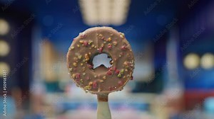 Chocolate round ice cream on a stick rotating in slow motion. Frozen donut rotation.