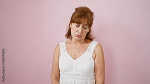 Angry and upset middle age woman wearing pink dress, crying over her hardships, wall of stress, isolated in despair