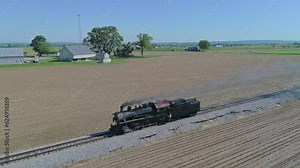 Drone View of a Steam Locomotive Traveling by Itself on a Test Run Thru Countryside in Slow Motion