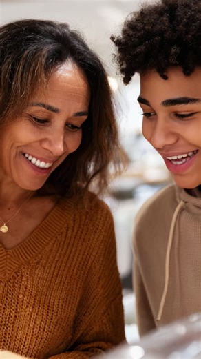 Joyful Moments: A Mother and Son Bond Over Shared Experiences in a Warm, Engaging Environment Showcasing Their Smiles and Connection Through Shared Activities | Premium Stock Video Footage