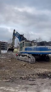Kibag's Komatsu PC340 on straight boom loading a truck with concrete | RPA Media