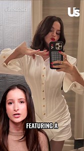 14K views · 35 reactions | Selena Gomez is serving springtime chic in all white with a pop of red!  She took to Instagram to show off her fresh seasonal style — including a crisp mini dress with pleated details, gold buttons, and a curve-hugging wrap skirt. Talk about a clean, classic slay with a bold twist ✨ Click the link for the full details. https://usweekly.visitlink.me/PHg_fA | Us Weekly | Facebook