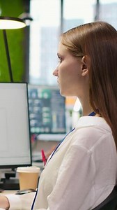 Vertical Female technician testing machine learning algorithms at work. IT professional scaling productivity with artificial intelligence large language model written code, camera A