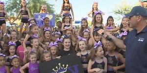 Kids' cheerleaders, Howler helps out at Paul's Car Wash