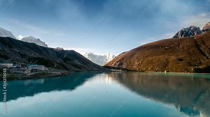Gokyo Lake, part of Everest Base Camp trek. Sagarmatha National Park, Nepal. Nature landscape. Holidays, travel, recreation. Water waves move and clouds in sky flow. 4K Slow Motion Time Lapse Parallax