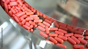 capsule manufacturing. capsule pill making process in a pharma factory. Pharmaceutical manufacturing tablet pill production line. medicine drug tablets capsule on medical device