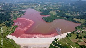 Red mud. Polluted lake in nature. Aluminum production and environmental impact. Bauxite residue. Dump pond containing toxic waste.