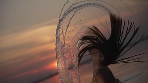 Dramatic Hair Flip in Sunset Arc