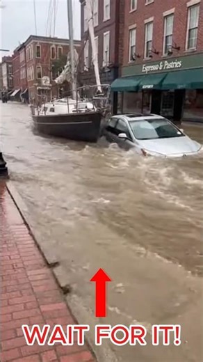 Sailboat Drifts Through Flooded Downtown Street