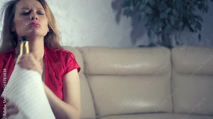 woman gets drunk at home alone at a table set for two for a romantic date, as her partner did not come on a date