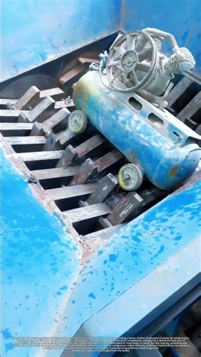 Worker Feeding Scrap Air Compressor into Powerful Shredder