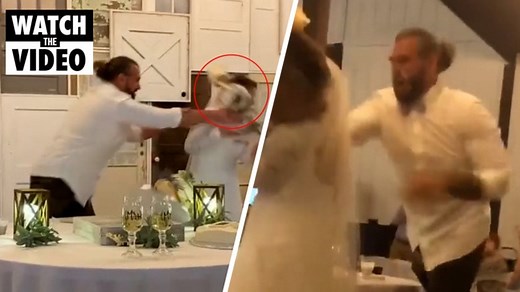 Groom slams bride in the face with wedding cake