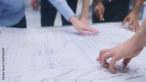 In the Industrial Engineering Facility: Diverse Group of Engineers and Technicians on a Meeting Gather Around Table Unravel Sheets of Engine Design Technical Drafts, Analyse Drawings. Focus on Hands