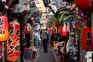 Japan warns of COVID-19 surge, Tokyo raises alert level