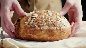 Whole grain bread put on kitchen wood plate by the chef in bakery. Fresh bread on table close-up. Fresh bread on the kitchen table The healthy eating and traditional
