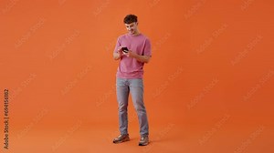Young man scrolling through phone feed with surprising news