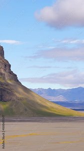 Drone footage captures the breathtaking, rugged terrain of Iceland's natural landscapes. The cinematic flyover highlights impressive cliffs, vast plains, and striking natural beauty.