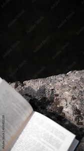 Vertical video background with book turning pages in wind, minimalist and dark, reading aesthetic