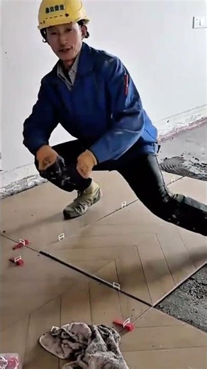 Installing large chevron patterned floor tiles using suction cups and plastic tile spacers