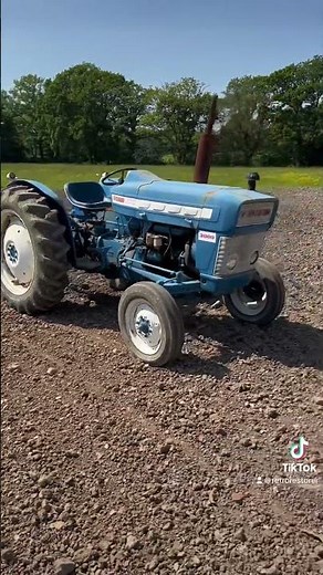 Ford 3000 Super Dexta Tractor using the chain harrow