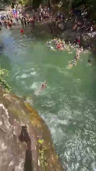 Woman Trips at 25-Foot Cliff Edge, Dives Into Water