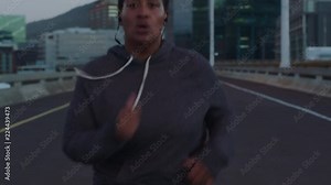 overweight african american woman runner resting exhausted after difficult running cardio exercise tired black female in urban city at sunset