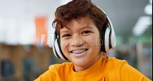 Face, library and child in headphones for online class, remote education or elearning with smile. Virtual school, portrait and happy boy student listening on headset technology on teaching platform