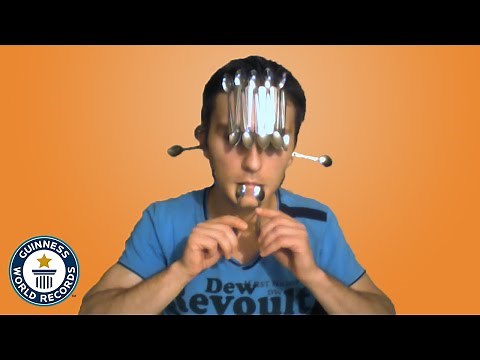 How many spoons can he balance on his face? - Guinness World Records