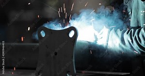 Worker Welding Metal Carefully At A Factory - Heat And Sparks From Welding Tool - slow motion close-up shot Stock Video